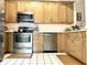Kitchen featuring stainless steel appliances and light wood cabinets at 3404 Maritime Dr, Indianapolis, IN 46214