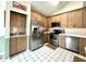 Kitchen featuring stainless steel appliances, light wood cabinets, and white backsplash at 3404 Maritime Dr, Indianapolis, IN 46214