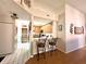 Open view to kitchen with bar seating, wood cabinets and modern appliances at 3404 Maritime Dr, Indianapolis, IN 46214