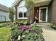 Charming home exterior with landscaped flower bed and decorative statue at 3404 Maritime Dr, Indianapolis, IN 46214