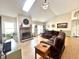 Bright living room featuring brick fireplace and natural light from skylight at 3404 Maritime Dr, Indianapolis, IN 46214