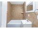 This bathroom features tile walls, a shower and bathtub combination, and modern fixtures at 3614 N Whittier Pl, Indianapolis, IN 46218