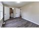 Bright bedroom featuring hardwood floors, neutral walls, and an adjacent bathroom for easy accessibility at 3614 N Whittier Pl, Indianapolis, IN 46218