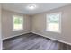 Bedroom with luxury flooring and large windows to see outside at 3614 N Whittier Pl, Indianapolis, IN 46218
