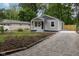 Charming home with a gravel driveway and freshly seeded lawn at 3614 N Whittier Pl, Indianapolis, IN 46218