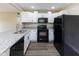 Contemporary kitchen with white cabinets and sleek, black appliances at 3614 N Whittier Pl, Indianapolis, IN 46218