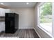 A kitchen featuring modern, black appliances and luxury flooring at 3614 N Whittier Pl, Indianapolis, IN 46218