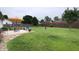 Large backyard with a patio seating area, mature trees, and a wooden privacy fence at 3645 Richland Dr, Columbus, IN 47203