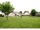 Spacious backyard featuring a patio set, bird bath and well-maintained landscaping at 3645 Richland Dr, Columbus, IN 47203