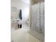 Well-lit bathroom featuring a decorative vanity table and a stylish shower curtain at 3645 Richland Dr, Columbus, IN 47203