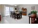 Bright dining room with a dark wood table set for six near sliding glass doors at 3645 Richland Dr, Columbus, IN 47203