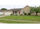 Charming brick home with a well-maintained lawn, attached garage and a red front door at 3645 Richland Dr, Columbus, IN 47203