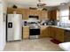 Well-lit kitchen with stainless steel appliances, light wood cabinets and tiled floors at 3645 Richland Dr, Columbus, IN 47203