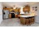 Spacious kitchen features wooden cabinets, modern appliances, and a cozy breakfast bar at 3645 Richland Dr, Columbus, IN 47203