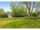 Spacious backyard with lush green lawn, mature trees, and a charming picket fence at 3713 Coventry Way, Carmel, IN 46033