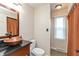 Bathroom with copper bowl sink, dark granite counter, and neutral color scheme at 3713 Coventry Way, Carmel, IN 46033