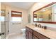 Bright bathroom with granite countertop, wood finishes, and a glass-enclosed shower at 3713 Coventry Way, Carmel, IN 46033
