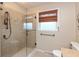 Bathroom boasts a glass enclosed shower with decorative tile and a window at 3713 Coventry Way, Carmel, IN 46033