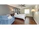 Spacious main bedroom with neutral colors, ceiling fan, and hardwood floors at 3713 Coventry Way, Carmel, IN 46033