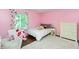 Pink bedroom with hardwood floors, white furniture, and a window at 3713 Coventry Way, Carmel, IN 46033