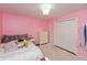 Pink bedroom with a chandelier, plush rug, dresser, and closet at 3713 Coventry Way, Carmel, IN 46033