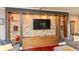 Entertainment center with stone backsplash and custom storage solutions, designed for media and display at 3713 Coventry Way, Carmel, IN 46033
