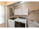 Laundry room with modern washer and dryer, utility sink and storage at 3713 Coventry Way, Carmel, IN 46033