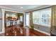 Bright living room with hardwood floors, view to kitchen, and lots of natural light at 3713 Coventry Way, Carmel, IN 46033