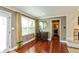 A living room featuring hardwood floors, a large window, and neutral-colored walls at 3713 Coventry Way, Carmel, IN 46033