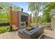 Beautiful outdoor patio with a fireplace, comfortable seating, and elegant decor at 3713 Coventry Way, Carmel, IN 46033