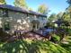 A beautiful backyard featuring a hot tub, a wooden deck with a gazebo, and mature trees for privacy and shade at 3819 S Village Dr, New Palestine, IN 46163