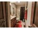 Well-lit bathroom with a shower-tub combo, wood vanity, and decorative accents at 3819 S Village Dr, New Palestine, IN 46163