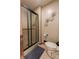 Cozy bathroom with glass enclosed shower, neutral paint, and decorative accents at 3819 S Village Dr, New Palestine, IN 46163