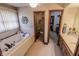 Inviting bathroom featuring a large soaking tub, double sink vanity, and access to a spacious walk-in closet at 3819 S Village Dr, New Palestine, IN 46163