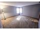 Spacious carpeted bedroom featuring a corner window allowing for natural light at 3819 S Village Dr, New Palestine, IN 46163