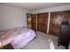 This is an image of the light and airy bedroom with access to multiple closets and a view of the hallway at 3819 S Village Dr, New Palestine, IN 46163