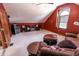 Bonus room with red walls, kitchenette, shelving and comfortable seating area at 3819 S Village Dr, New Palestine, IN 46163