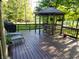 This property boasts a spacious deck with gazebo, hot tub, and outdoor seating areas for gatherings and relaxation at 3819 S Village Dr, New Palestine, IN 46163