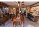 Inviting dining room featuring a wooden table set, ceiling fan, and bar with granite countertop at 3819 S Village Dr, New Palestine, IN 46163