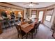 Dining room with a large wood table, chairs, and breakfast bar with access to the kitchen at 3819 S Village Dr, New Palestine, IN 46163
