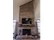 Floor to ceiling brick fireplace with black screen, mantel and hearth, flanked by arched windows at 3819 S Village Dr, New Palestine, IN 46163
