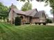 Charming two-story home with brick facade, attached two-car garage and manicured front lawn at 3819 S Village Dr, New Palestine, IN 46163