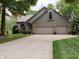 Side view of a two-car garage with a basketball hoop adjacent to the driveway at 3819 S Village Dr, New Palestine, IN 46163