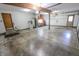 Organized garage interior featuring ample space, lighting, utility sink, and storage at 3819 S Village Dr, New Palestine, IN 46163