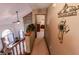 This is an image of the hallway with a view into the living room with fireplace and a bedroom at 3819 S Village Dr, New Palestine, IN 46163