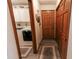 Hallway near laundry room featuring a closed closet door, tile flooring, and wall decorations at 3819 S Village Dr, New Palestine, IN 46163