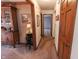 Hallway with carpet, a wine rack under a table lamp, and a view into another room at 3819 S Village Dr, New Palestine, IN 46163