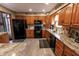 Spacious kitchen featuring stainless steel appliances, stone countertops, and ample cabinetry at 3819 S Village Dr, New Palestine, IN 46163
