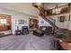 Spacious living area with staircase, neutral carpeting, and cozy seating arrangement at 3819 S Village Dr, New Palestine, IN 46163