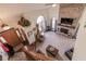 Open-concept living room with a brick fireplace, large windows, and comfortable seating at 3819 S Village Dr, New Palestine, IN 46163